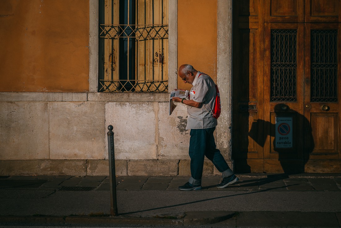 Местный итальянец читает газету на ходу